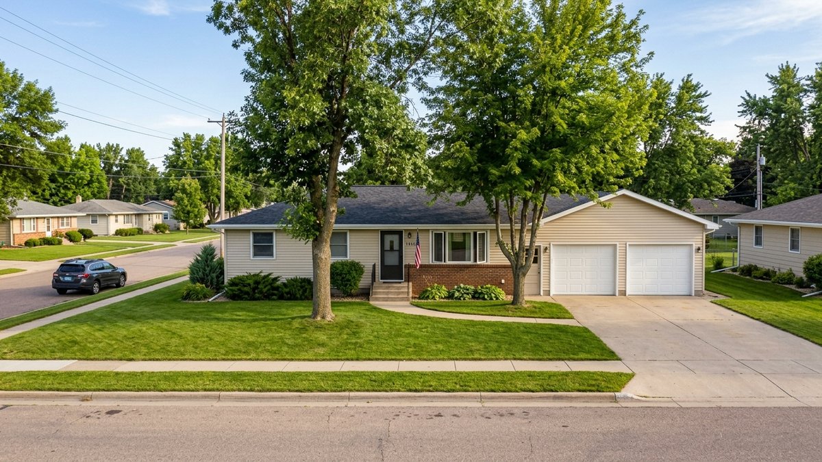 Typical mid-priced single-story ranch home in a Yankton, SD residential neighborhood, casual daylight.